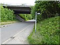 Public footpath sign and in the background a bridge on the Louth bypass A16