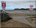 Public notices at the edge of Ferryside Beach