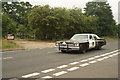 View of a 1974 Dodge Monaco passing along London Road as part of the London-Southend Classic Car Run