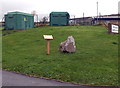 Waymarker stone and two electricity substations near the main entrance to Maesteg School