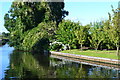 Well-tended canalside garden at Coven Heath