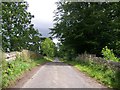 Unclassified road east of Lour crossing the bridge over the rail track bed