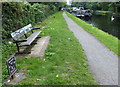 Seat and milepost along the Grand Union Canal towpath