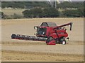 NU2404 : Harvesting wheat at New Barns by Graham Robson