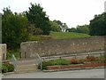 Nondescript grassy mound and enclosing wall