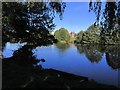 View across lake to Capesthorne Hall near Siddington