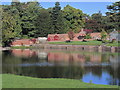 View across lake to gardens at Capesthorne Hall near Siddington