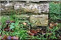 Benchmark on A3400 wall pier at road to Hull Farm