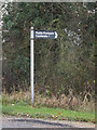 TL3657 : Footpath sign off Main Street by Geographer