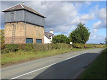 NT6932 : Road (A699) and Water Tower at Trows by Peter Wood