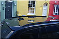 View of coloured houses reflected in a car roof on Godfrey Street