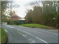 Looking west across Capel Road from farm entrance