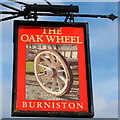 Sign for the Oakwheel public house, Burniston