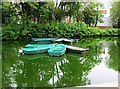 Boats moored on the lake by the Boathouse, Pittville Park, Cheltenham, Glos