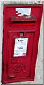 King George VI postbox in the wall of Bynea General Store