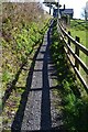 Fence shadows along the path at Strete