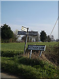 TM1656 : Roadsign & Pettaugh Lane sign by Geographer