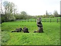 Woodcarvings of three otters in Bourton Park, Buckingham