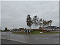 Looking across a roundabout towards a "Harvester"