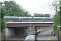 View of a Chiltern Railways train crossing the bridge over Rectory Road