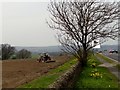 Farmer harrowing a field near Rowley