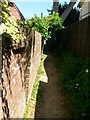 Throop: slightly leaning brick wall alongside footpath K26