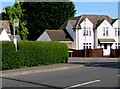 Bus stop pole in a hedge, Bridgend, Stonehouse