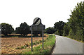 TG1115 : Honingham Road and Weston Longville village name sign by Geographer