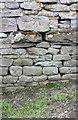 Benchmark on barn on east side of Angram Lane