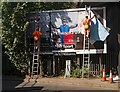 TQ2191 : Billboard poster change-over, Bunns Lane, Mill Hill by Jim Osley