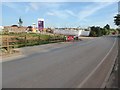 Road passing a Taylor Wimpey housing development