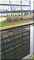 Office windows reflected in the Leeds and Liverpool Canal