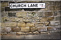 Benchmark under Church Lane name sign