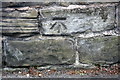 Benchmark on wall outside Savile House, Harrogate Road