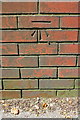 Benchmark on wall beside steps from North Street