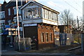 Former signal box by level crossing at Highams Park