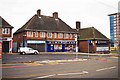 SJ8288 : Shops and bus stop in Hollyhedge Road, Wythenshawe, Manchester by P L Chadwick
