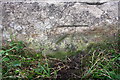 Benchmark on Leeming Lane wall near racecourse grandstand