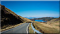 NM5564 : Looking north along the B8007 to Rhum and Eigg by Peter Moore