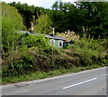 Corrugated metal house above the A4046 at the southern edge of Cwm