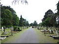 Cutting the grass within East Sheen Cemetery