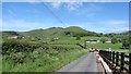 Tractor and low loader descending to the valley floor along Slievehanny Road