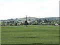 View across cropland towards a classic shaped drumlin