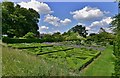 Helmingham Hall: The Herb and Knot Gardens with Rose Garden beyond