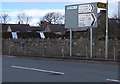 Directions and distances signs at a Nottage junction