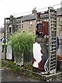 Old petrol pumps outside closed-down garage