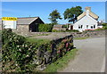 Milk churn stand on A487 west of Newport