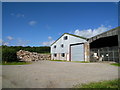 Farm buildings and a large pile of rubble