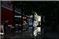 View of the More London development reflected in one of the fountains