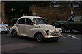 View of a Morris Minor 1000 leaving Greenwich Park from King William Walk